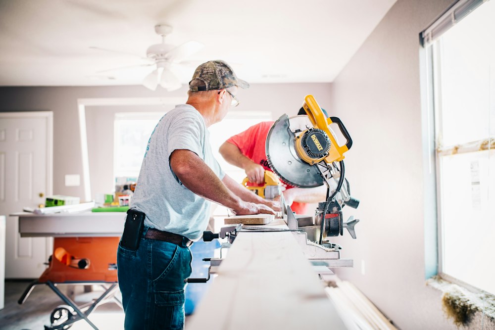 Craftsmen cutting boards with a miter saw