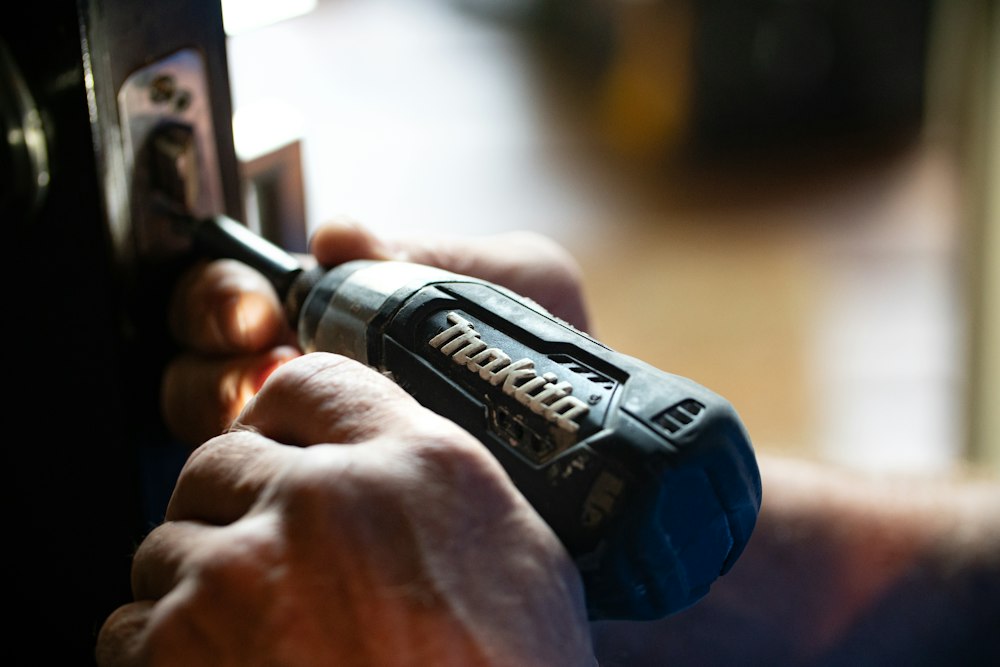 Hands working with a cordless screwdriver